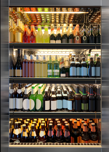 Refrigerator with rows of shelves full of drink bottles.