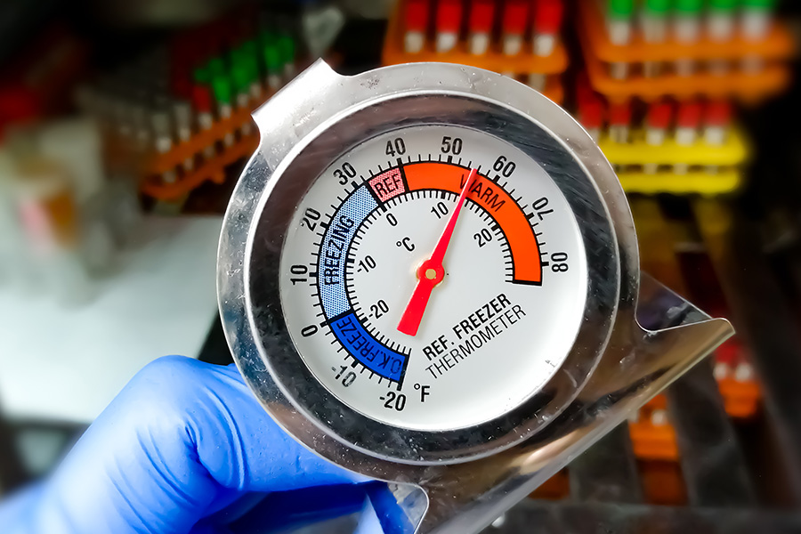 Freezer thermometer showing warm temperatures within a freezer.